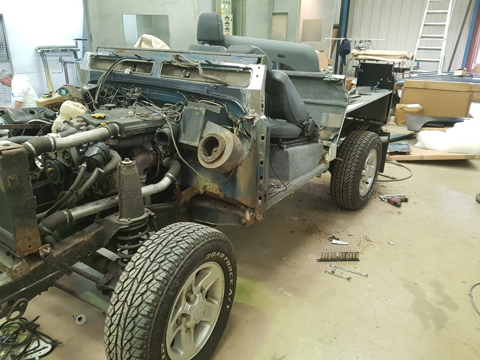Land Rover Defender stripped to the chassis with bodywork and panels removed before restoration
