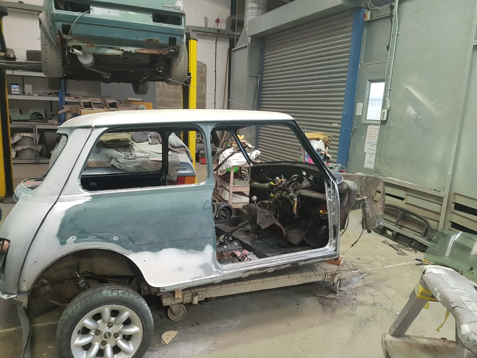 Classic Mini shell stripped back before restoration, old paint sanded and interior removed