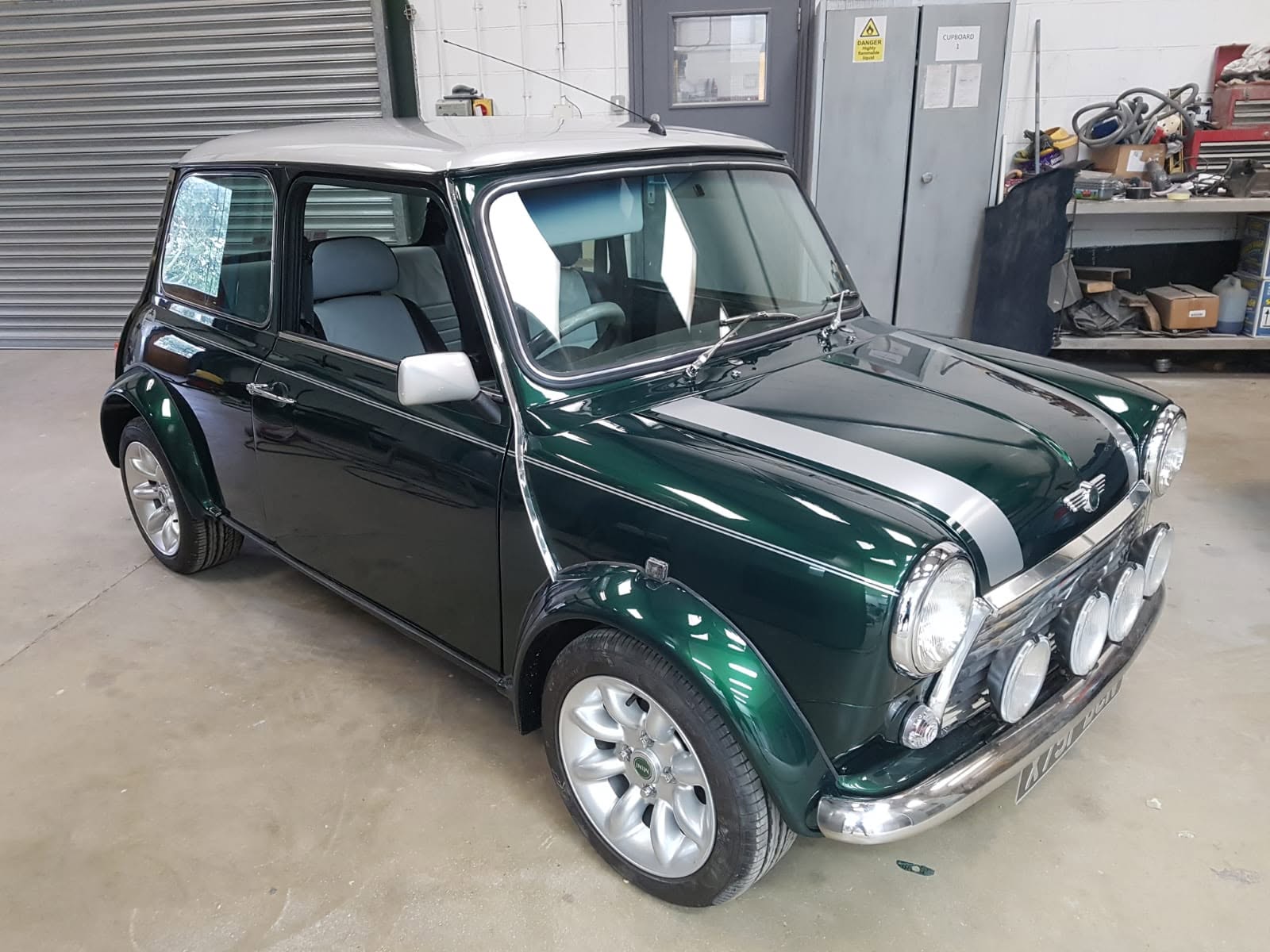Finished British racing green Mini with white roof and bonnet stripes, fully rebuilt